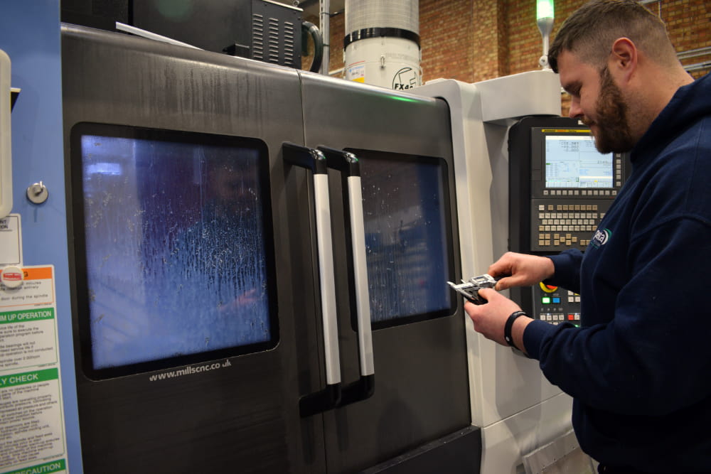 Machine operator with calipers